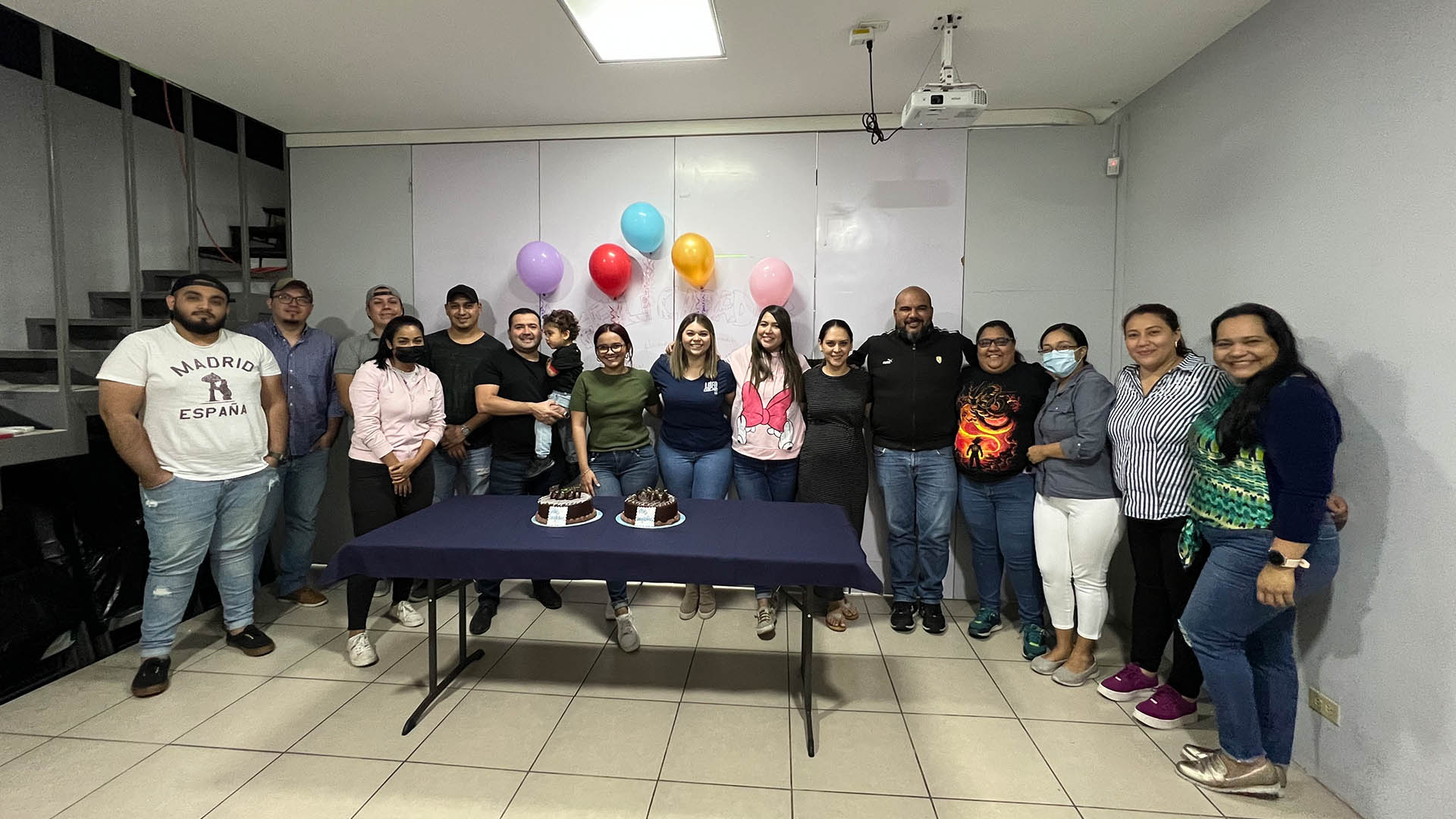 Imer Vigil, sixth from left holding the child, with his Happy Tours Travel Agency team in El Salvador.