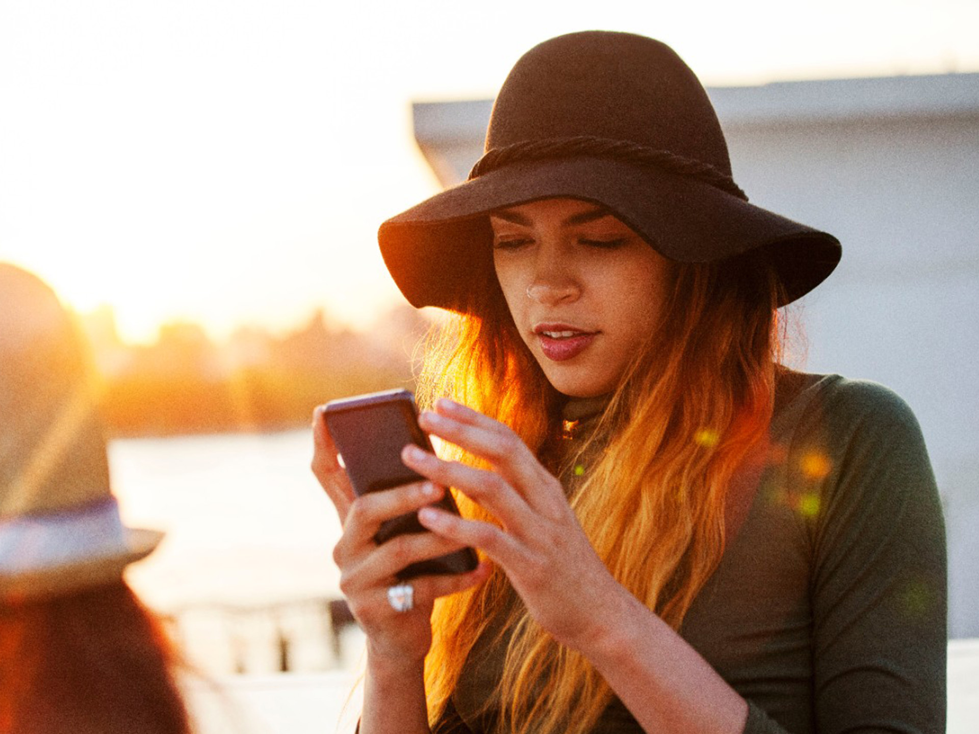 A woman looks at a smartphone