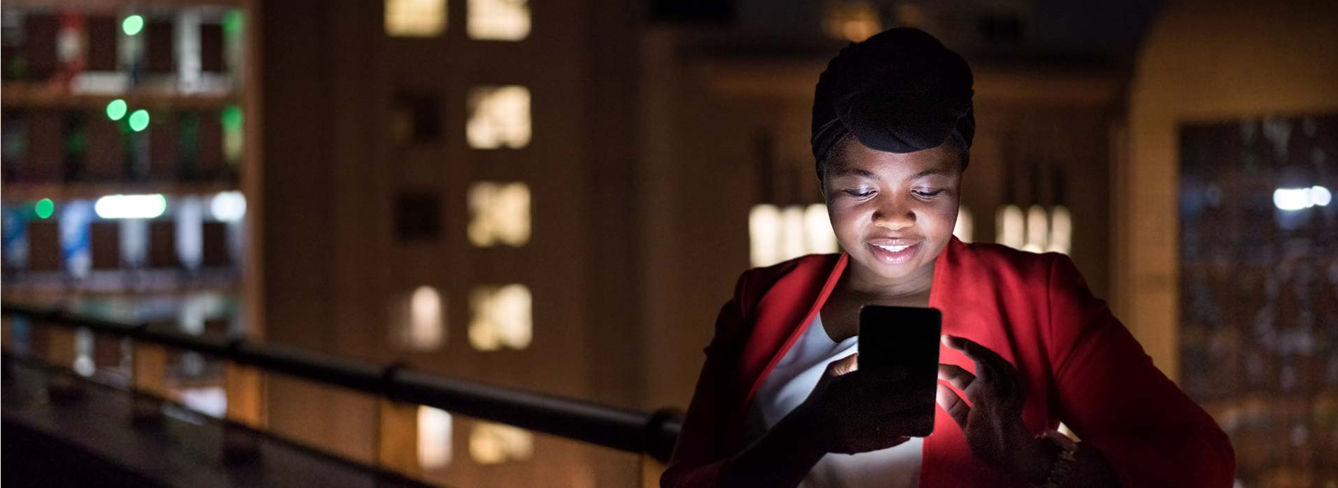 A woman looks at a smartphone