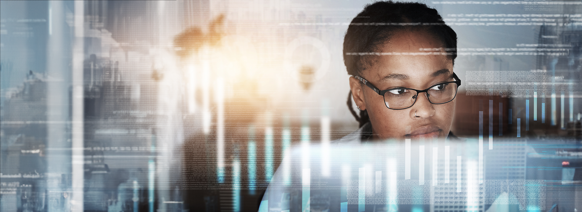 Woman reviewing data on a computer and heads up display