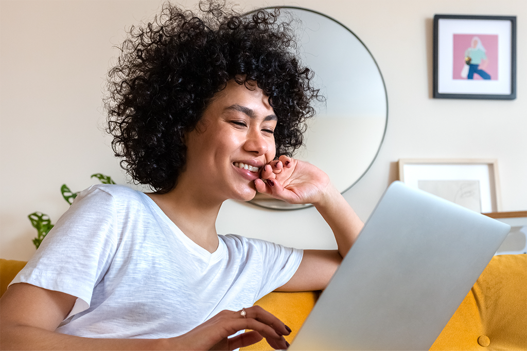 Person sitting and reading a screen. Image header for Leading in Identity report